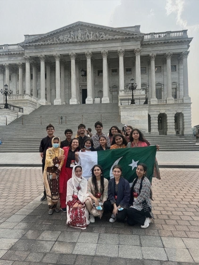 FLEX participants from Pakistan holding the Pakistani flag in front of the U.S. Capitol